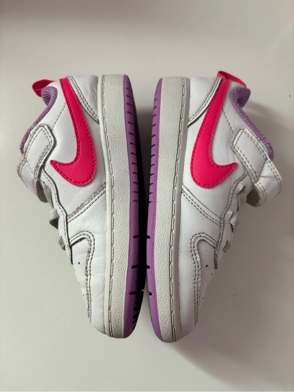 Nike White Sneakers with Bright Pink Swoosh and Lavender Soles